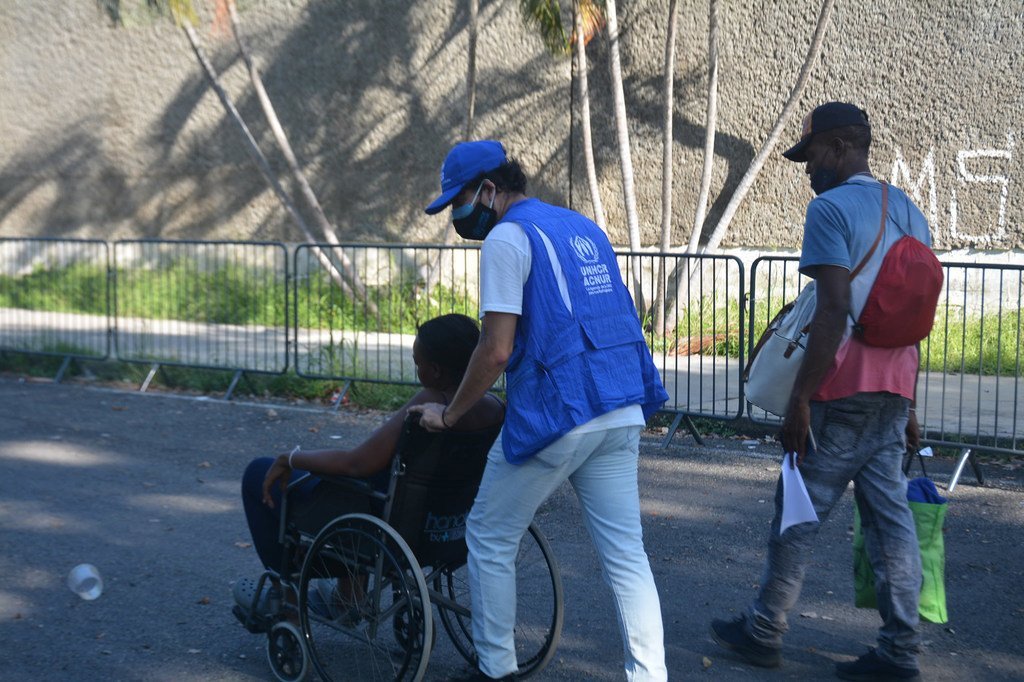 Personal de ACNUR asistiendo a una persona migrante en el Estadio Olímpico de Tapachula, Chiapas, en noviembre de 2021. 