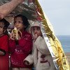Tres niñas refugiadas se resguardan bajo una manta de emergencia tras llegar a las costas de Lesbos, en Grecia.